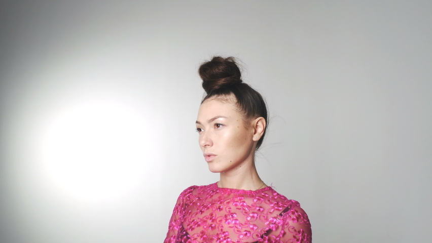 Portrait of beautiful woman in red dress fluttering in wind. Fabric waving in the wind. Fashionable image for advertising perfumes or other concepts