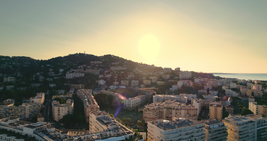 Aerial video of seaside downtown, sea, mountain, blue sky at sunrise with on the horizon. Cannes, France. Royalty-Free Stock Footage #1076118947