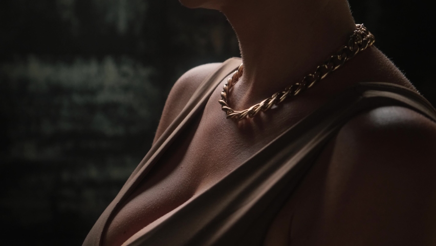 Sexy blonde with a gold chain and luxurious earrings.