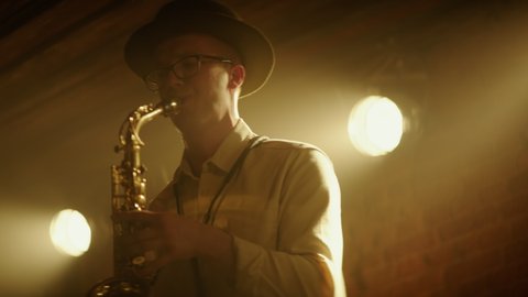 HANHDHELD CU Portrait of jazz band playing saxophone on stage during a live concert in small venue. Shot on ARRI Alexa Mini LF with 2x anamorphic lens