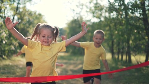 Kid are run. Child run through forest park to finish line. Victory and Success. Kid is winner. Happy child run in forest park. Baby run to finish line. Baby path to success and victory. Child winner