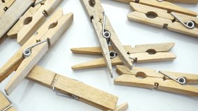 Close-up of wooden clothespins on a white background with rotation, top view