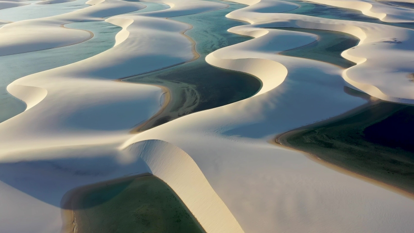 Lençois Maranhenses, Maranhao, Brazil. Scenic sand waves at Lençois Maranhenses National Park. Great sand dunes between rainwater lakes. Paradise natural sand dunes of Lencois Maranhenses Maranhao.