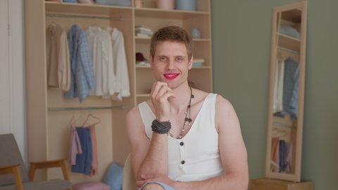 Portrait young smiling transgender man transsexual applying make-up looking at camera, LGBTQ Man wearing women's clothing with makeup. womanlike man on face and woman clothes, fashion glamorous