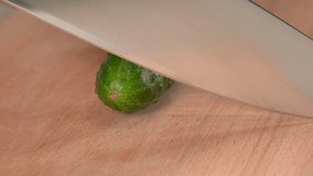 Cutting fresh cucumber on a cutting board close up. Chopping  fresh cucumber close up.
