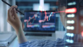 Business woman sitting front laptop computer with financial graphs and statistics on monitor. Using laptop to buy or sell shares, double exposure, internet trading concept - Powered by Shutterstock - Get 15% off with code: PIKWIZARD15
