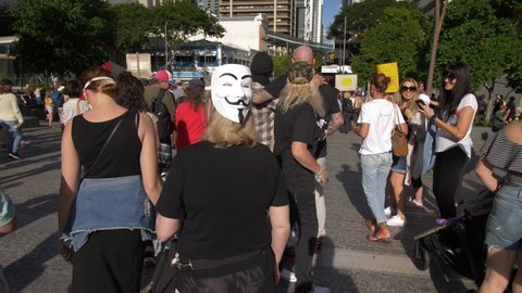 BRISBANE, QUEENSLAND, AUSTRALIA. MAY 30 2020. Guy Fawkes masks at Anti Vaccine demo, slow motion.