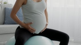Pregnant Woman Doing Exercises On Fitness Ball At Home, Closeup Shot Of Expecting Woman With Big Belly Training On Fitball In Living Room Interior, Getting Ready For Childbirth, Slow Motion Footage - Powered by Shutterstock - Get 15% off with code: PIKWIZARD15