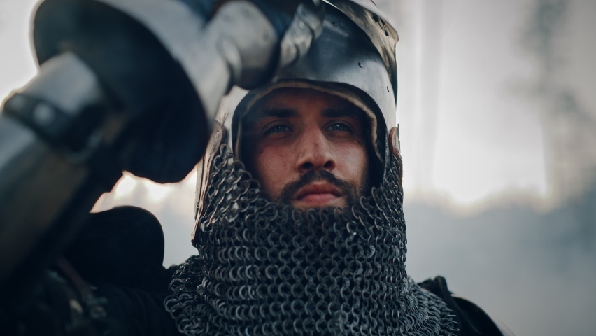 Medieval Knight on Battlefield, Looking at Camera, Closes his Helmet for Battle. Portrait of Mighty Warrior, King, Soldier at War, Conquest, Crusade. Dramatic Scene, Cinematic Historic Reenactment | Shutterstock HD Video #1076140736
