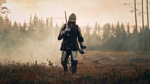 Lonesome Medieval Knight Marching Through Forest. Invaded, Colonizer, Crusader, Soldier, Warrior Wearing Body Armor, Helmet, Shield and Sword Traveling Through Mysterious Land Tracking Wide Front View