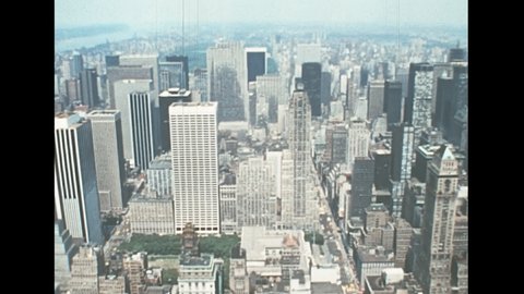 Midtown Manhattan aerial on Bryant Park of New York with 1900s buildings and taxi on the road. Archival skyline of New York on Central Park side in 1970s. Vintage United States of America in 1976.