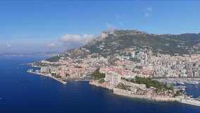 Monte Carlo, Monaco. Aerial view of famous city towering over Mediterranean Sea, ships and boats in yachting marina Port de Fontvieille - landscape panorama of Europe from above