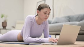 Latin Woman Talking on Video Call on Laptop on Yoga Mat 