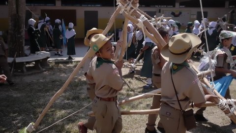 Yala, Thailand March 11, 2016  Thai Boy Scout activities joyful boys and girls teams bring hand made wooden catapult to play with water balloons, happy and fun, Muslim Students Ban Yala primary school