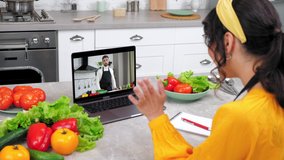 Smiling woman in home kitchen study online video call webcam chat laptop listen chef teacher. Man food blogger in computer screen greets tells teaches housewife remote cooking culinary webinar lesson