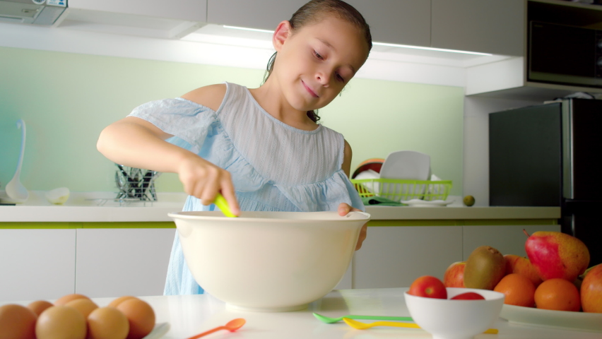 happy cute eight-year-old girl cooking kitchen Stock Footage Video (100 ...