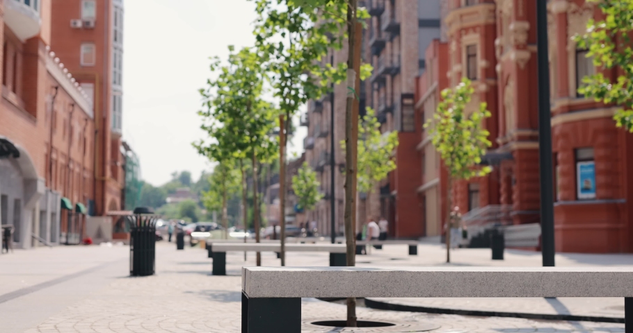 Man freelancer opening and using laptop sitting at the city