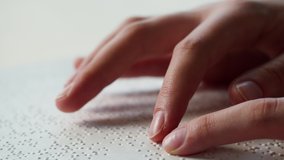 Touching letters on sheet of paper close-up, blindman reading braille book using his fingers, poorly seeing person learning to read, disabled people concept.  - Powered by Shutterstock - Get 15% off with code: PIKWIZARD15