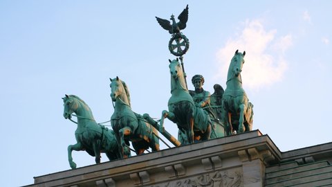 Brandenburger Tor in Berlin with Quadriga statue on top, close up on the evening on a sunny day