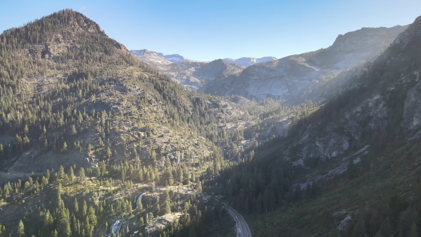 Drone flying over emerald bay towards Eagle Falls and Desolation Wilderness During golden hour Tahoe California.
