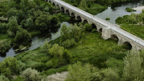 Roman Bridge Of Salamanca Over The Tormes River On The Banks Of The Spanish City Of Salamanca. aerial, orbit