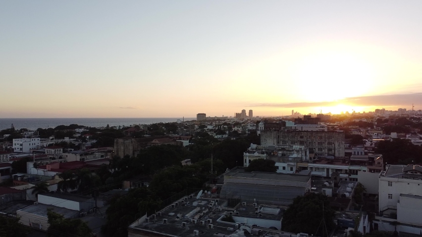 Aerial shot of Santo Domingo Dominican Republic. Street of houses, downtown with a beautiful sunset.