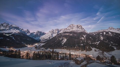 Day-night timelapse of the Drei Zinnen (Tre Cime di Lavaredo) valley in the Sexten Dolomites of northeastern Italy. The village of Moos.