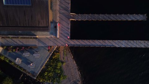 Top down view of Windermere Jetty near Bowness-on-Windermere, Lake District, UK, during golden hour evening sunset
