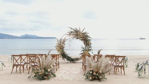 Wedding beach set up for seaside and cloudy sunny day.Wedding Woods chair's gold concept. wedding event patterns island on sunset.blue sea and sky.