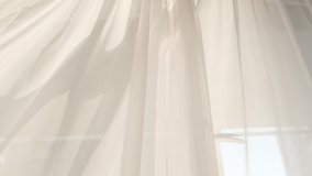 Transparent white curtain tulle moves from the wind from an open window. Sunny day, the sun's rays sunlight. - Powered by Shutterstock - Get 15% off with code: PIKWIZARD15