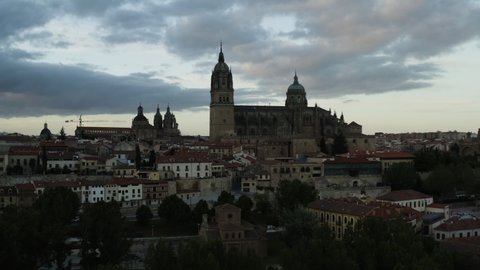 View Of New And Old Cathedrals Of Salamanca In Spain With Overcast. Tower Clerecia In Distant Background. wide drone shot