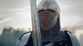 Medieval Knight Wearing Armour and Helmet, Draws Sword from Shearh, Ready to Fight, Kill His Enemy in Battle. Warrior Soldier on Battlefield. War, Invasion, Crusade. Cinematic Historic Reenactment - Powered by Shutterstock - Get 15% off with code: PIKWIZARD15