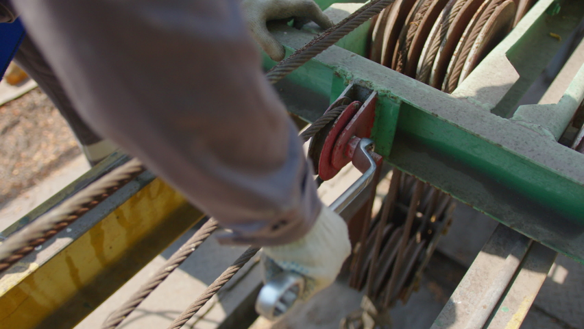Workers installing supply pipeline system, close up.