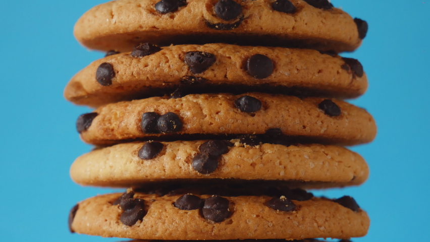 A stack of chocolate chip cookies sprout on a blue background. American cookies close up | Shutterstock HD Video #1076183390