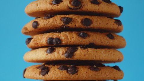 A stack of chocolate chip cookies sprout on a blue background. American cookies close up