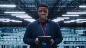 Portrait of a Data Center Engineer Using Laptop Computer. Server Room Specialist Facility with African American Male System Administrator Working with Data Protection Network for Cyber Security. - Powered by Shutterstock - Get 15% off with code: PIKWIZARD15