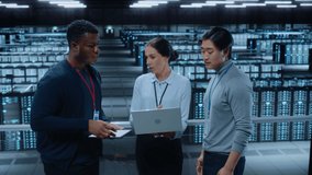 Diverse Team of Data Center System Administrators and IT Specialists Talk, Use Laptop and Tablet Computers. IT Engineers work on Cyber Security Network Protection in Cloud Computing Server Farm. - Powered by Shutterstock - Get 15% off with code: PIKWIZARD15