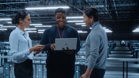 Diverse Team of Data Center System Administrators and IT Specialists Talk, Use Laptop and Tablet Computers. IT Engineers work on Cyber Security Network Protection in Cloud Computing Server Farm. - Powered by Shutterstock - Get 15% off with code: PIKWIZARD15