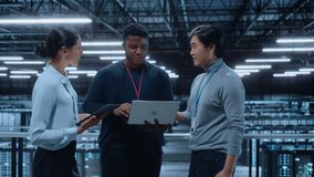 Diverse Team of Data Center System Administrators and IT Specialists Talk, Use Laptop and Tablet Computers. IT Engineers work on Cyber Security Network Protection in Cloud Computing Server Farm. - Powered by Shutterstock - Get 15% off with code: PIKWIZARD15
