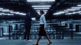 Data Center Engineer Using Laptop Computer. Server Farm Cloud Computing Specialist Facility with African American Male System Administrator Working with Data Protection Network for Cyber Security. - Powered by Shutterstock - Get 15% off with code: PIKWIZARD15