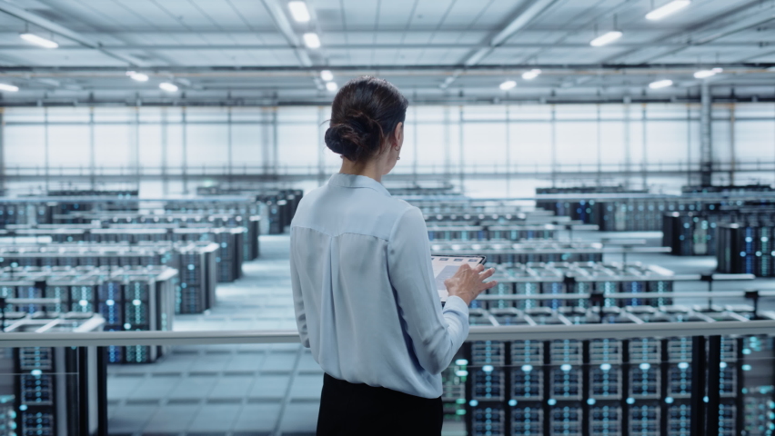 Data Center Engineer Using Tablet Computer. Server Farm Cloud Computing Specialist Facility with Multiethnic Female System Administrator Working with Data Protection Network for Cyber Security. Royalty-Free Stock Footage #1076186534