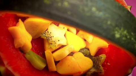 I cut the mango pieces in the shape of a heart and stars. I arrange the watermelon in the shape of a basket. 4k video