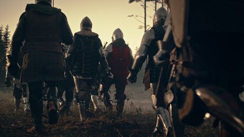 Invading Army of Medieval Knights Marching To Defeat Enemy. Armored Warriors Walking in Mysterious Forest. War, Battle, Crusade. Dramatic, Cinematic Historical Reenactment