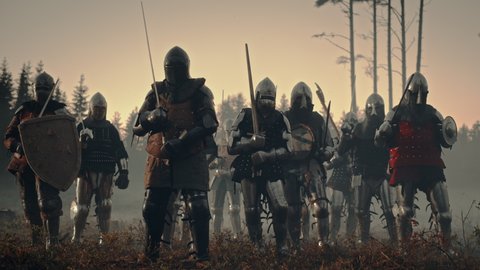 Epic Battle: Army of Medieval Knights on Battlefield, Scream Battle Cry and Charge with Attack on the Enemy. Armored Soldiers in Helmets, With Shields and Swords. Cinematic Historical Reenactment