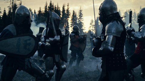 Epic Battlefield: Armies of Medieval Knights Fighting with Swords. Dark Ages Warfare. Action Battle of Armored Warrior Soldiers, Killing Enemies. Blue Cinematic Historical Reenactment. Slow Motion
