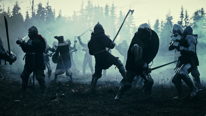Epic Battlefield: Armies of Medieval Knights Fighting with Swords. Dark Ages Warfare. Action Battle of Armored Warrior Soldiers, Killing Enemies. Blue Cinematic Historical Reenactment. Slow Motion