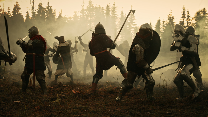 Epic Battlefield: Armies of Medieval Knights Fighting with Swords. Dark Ages Warfare. Action Battle of Armored Warrior Soldiers, Killing Enemies. Cinematic Historical Reenactment. Wide Slow Motion