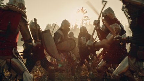Epic Battlefield: Armies of Medieval Knights Fighting with Swords. Brutal Battle of Armored Warrior Soldiers Attacking Enemy. War, Warfare, Crusade. Cinematic Historical Reenactment. Slow Motion
