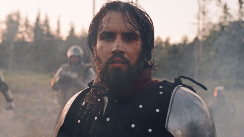 Handsome Medieval Knight King on Battlefield, Looking at Camera. Portrait of Mighty Warrior Soldier Contemplating Victory. War, Invasion, Conquest. Dramatic Scene in Cinematic Historic Reenactment Royalty-Free Stock Footage #1076193416