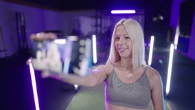 Cute fitness girl influencer record video with smartphone about rubber band 4K